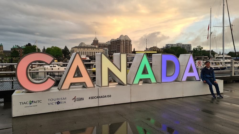 Neon light sign with the word Canada. Photo.